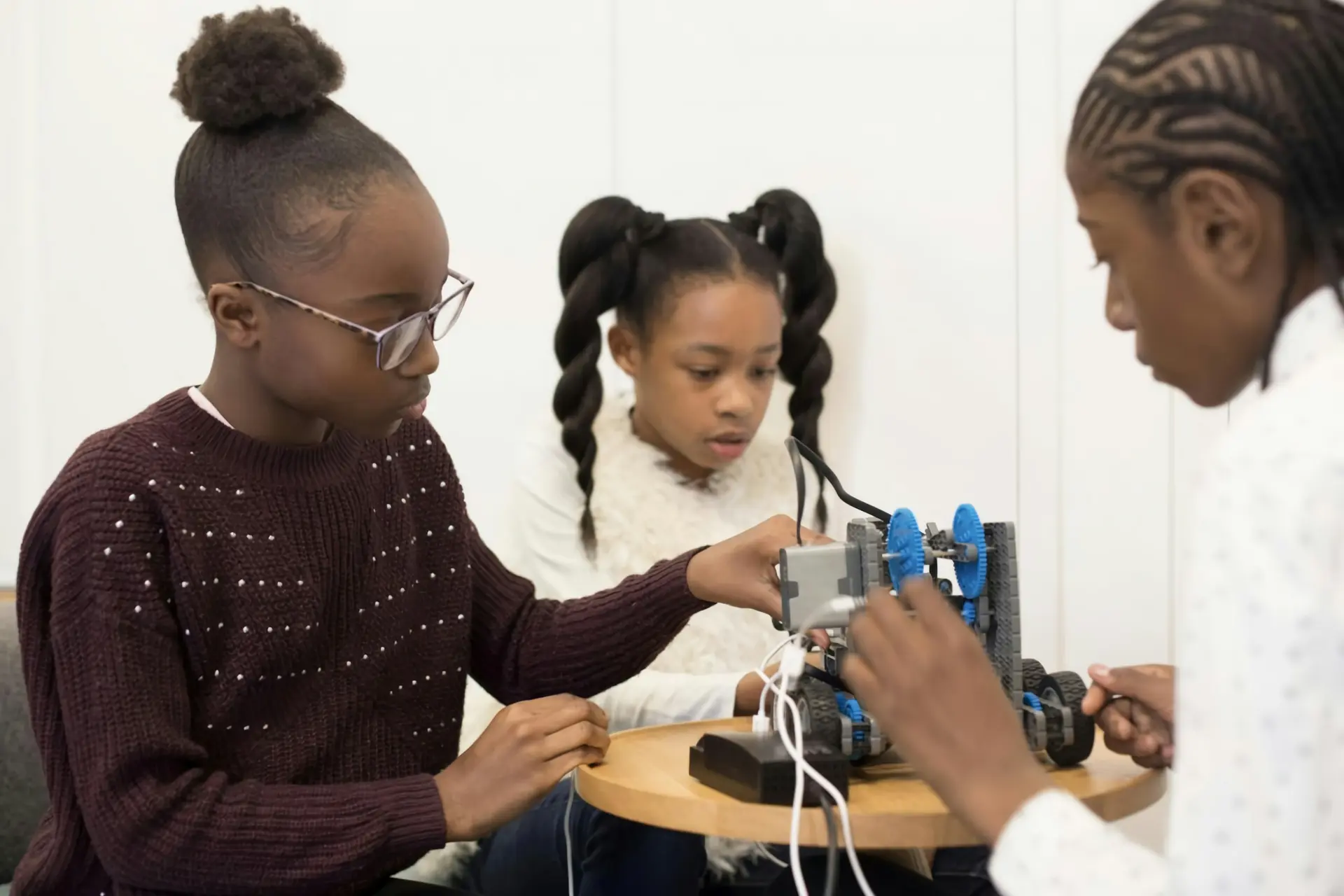 Girls building and testing a robot together